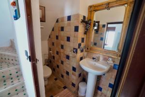a bathroom with a sink and a toilet and a mirror at CASA ADiL in Tangier