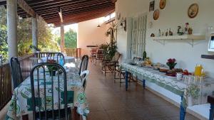 a dining room with a table and chairs on a balcony at Ana Terra Barretos in Barretos