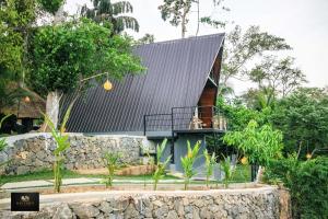 a house with a metal roof and a balcony at HAVENRO Weligama in Weligama