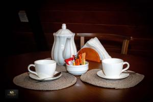 a table with two cups and a tea pot at HAVENRO Weligama in Weligama +13 photos