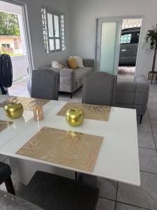 a living room with a white table and a couch at serenity in Fajardo