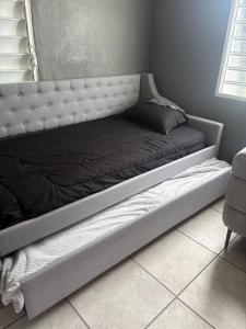 a bed in a room with a bed frame at serenity in Fajardo