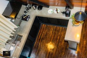 an overhead view of a kitchen with wood floors and a counter at HAVENRO Weligama in Weligama