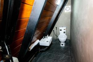 a small bathroom with a toilet and a sink at HAVENRO Weligama in Weligama
