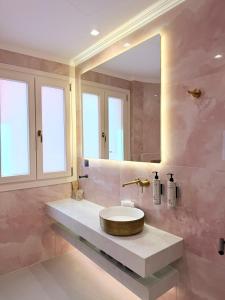 a bathroom with a sink and a mirror at The Residence Myrina in Myrina +59 photos