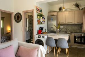 a kitchen with a table and chairs in a room at Vrachos Nature Lodges Thyme 1, Private pool in Agia Galini