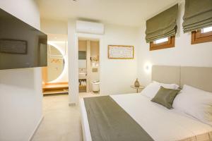 a bedroom with a large bed and a bathroom at Leon Apartments in Ierissos
