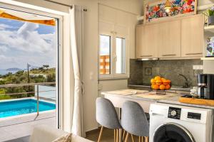 a kitchen with a view of a swimming pool at Vrachos Nature Lodges DAPHNE 2, Private pool in Agia Galini
