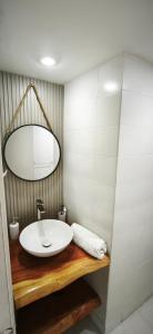 a bathroom with a white sink and a mirror at Apartamento Termas de Chillán in Nevados de Chillan