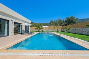 a swimming pool in a backyard with a house at villa tera Private Pool & jacuzzi in Fethiye