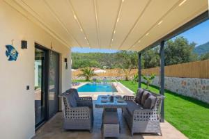 a patio with a table and chairs next to a pool at villa tera Private Pool & jacuzzi in Fethiye