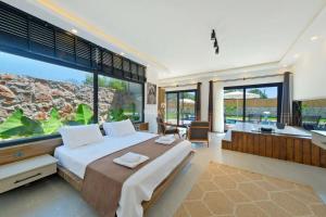 a bedroom with a large bed and a large window at villa tera Private Pool & jacuzzi in Fethiye +34 photos