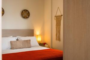 a bedroom with a bed and a clock on the wall at Vrachos Nature Lodges DAPHNE 2, Private pool in Agia Galini +27 photos