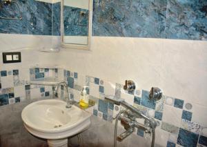 a bathroom with a sink and a mirror at Anurag Hotel Chakrata in Chakrāta