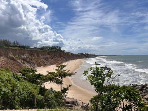 ein Strand mit einer Gruppe von Menschen, die darauf spazieren gehen in der Unterkunft Frida's Corner in Caucaia