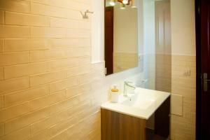 a bathroom with a sink and a mirror at Muellito de Famara in Famara