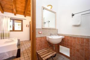 a bathroom with a sink and a bed and a mirror at B&B Stentadì in Quartucciu +93 photos