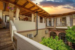 a large house with a balcony and a building at B&B Stentadì in Quartucciu