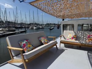 two chairs and pillows sitting on the back of a boat at WoonBoten Anna in Andijk