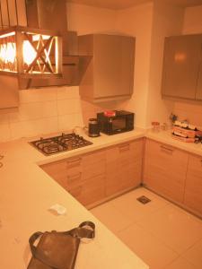 a kitchen with a stove and a microwave at Maison Veyra in Rawalpindi +12 photos