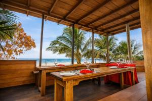 a dining room with a table with a view of the ocean at TBRS By Platinum Hotels in Trincomalee