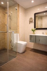 a bathroom with a shower and a toilet and a sink at TBRS By Platinum Hotels in Trincomalee