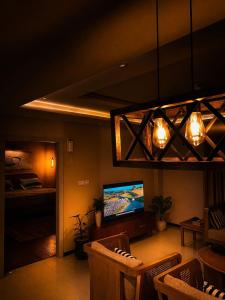 a living room with a television and a bed at Maison Veyra in Rawalpindi