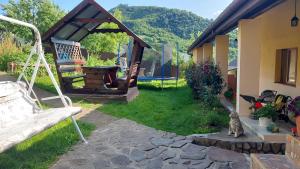 a yard with a swing and a house at У Інни in Mizhhirya