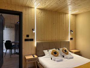 a bedroom with a bed with two pillows on it at Flore's Garden in Bran