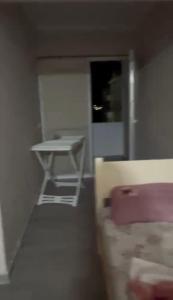 a room with a table and a bed and a desk at Azure Pine Apartament in Golem