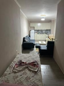 a living room with a couch and a living room with a table at Azure Pine Apartament in Golem