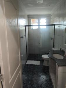 a bathroom with a toilet and a sink and a shower at Paraíso do Abais, house for rent in Estância +8 photos