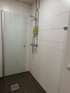 a shower in a bathroom with white tiled walls at Appartment in Espoo in Helsinki +10 photos