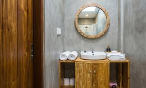 a bathroom with a sink and a mirror at Rumah Weda in Ubud