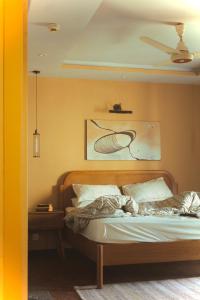a bedroom with a bed and a painting on the wall at Maison Veyra in Rawalpindi