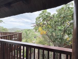 a balcony with a view of a tree at The Hide on 37 Flamingo in East London