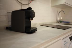 a coffee maker sitting on a counter in a kitchen at Estudio a 400 metros Ribera FREE PARKING in Córdoba +36 photos