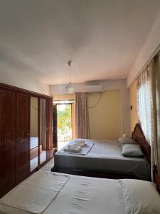 a bedroom with two beds and a window at Room zero of Sea in Borsh