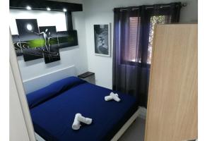 a bedroom with a blue bed with two bears on it at Casa Cristina in Costa Rei