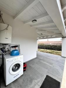 a washer and dryer sitting under a garage at Casa Cristina in Costa Rei