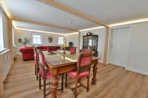 a dining room with a table and chairs at Ferienwohnung Harmony "Residenz" in Leisnig +10 photos