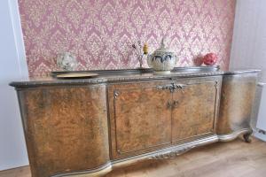 an old wooden cabinet in a room with a wall at Ferienwohnung Harmony "Residenz" in Leisnig