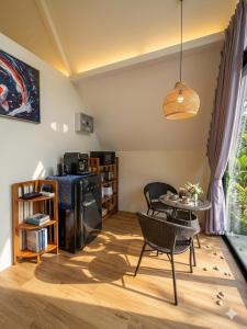 a living room with a table and chairs at Echo Falls Khanom in Ban Nua Tha