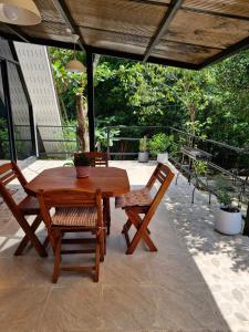 a wooden table and chairs on a patio at Echo Falls Khanom in Ban Nua Tha +16 photos