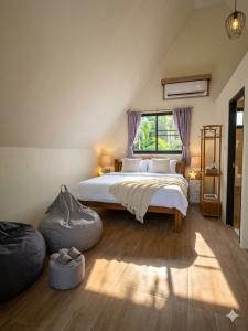 a bedroom with a large bed and a window at Echo Falls Khanom in Ban Nua Tha