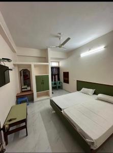 a bedroom with a bed and a tv in it at Hotel Sanman in Gulbarga