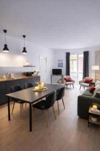 a living room with a table and a couch at 22CaLQuEROL Boutique centro suite lux in Puigcerdà