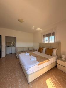 a large bedroom with a large bed and a couch at Antonios Apartments in Ulcinj