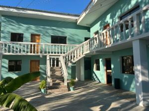 a blue building with a staircase on the side at Apartamentos Isabela in Casares