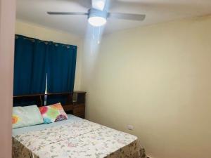 a bedroom with a bed and a ceiling fan at Apartamentos Isabela in Casares